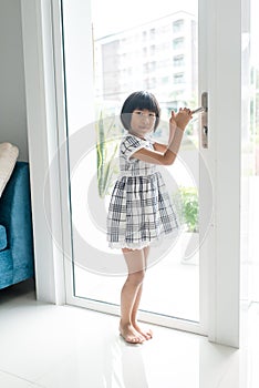 Asian girl opend door at home.