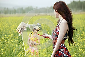 Asian girl painting in field