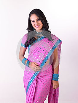 `Asian girl in pink sari with rich jewelery