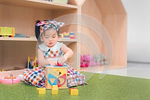 Asian girl play education toy at kindergarten preschool. Development chlidhood