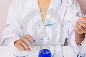 Asian girl playing as a scientist to experiment with laboratory equipment