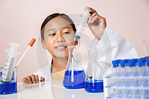 Asian girl playing as a scientist to experiment with laboratory equipment