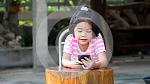 Asian girl playing games on smart phone joyfully