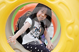 Asian girl playing at scholl playground with happiness, kid education photo