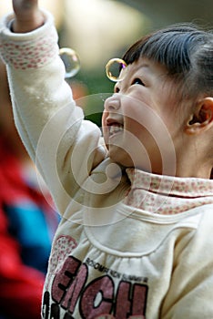 Asian girl playing the Soap bubble