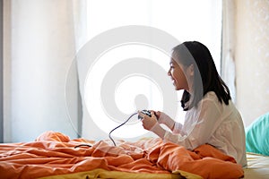 Asian girl playing video game