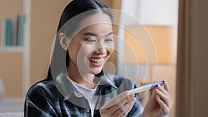 Asian girl pregnant happy girl surprised woman expectant future mother female parent holding looking at positive
