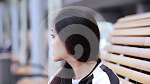 Asian girl with a pretty face sitting on a bench