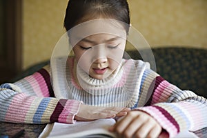 Asian girl reading a book