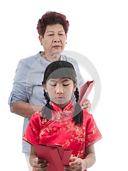 Asian girl in Red Chinese dress stressing with her grand mother.