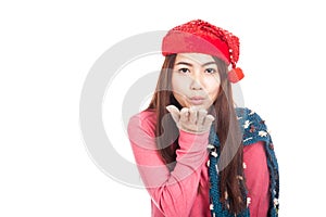 Asian girl with red christmas hat blowing a kiss