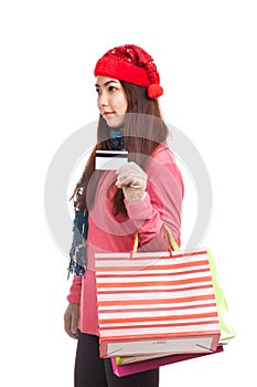 Asian girl with red christmas hat ,credit card and shopping bag