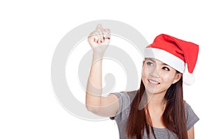 Asian girl with red santa hat write in the air and smile