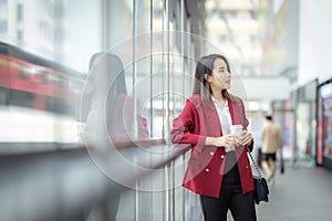 Asian girl relax with a office cup in worker uniform Stand in a department store