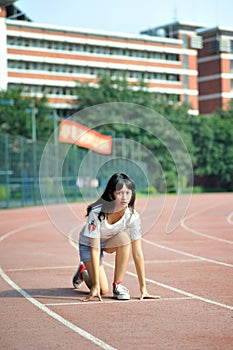 Asian girl on runway in school playground photo