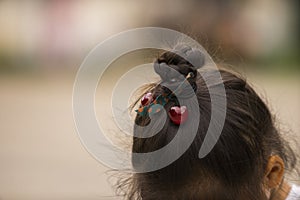 Asian girl\'s hairstyle with a braid around her head close-up.