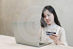 Asian girl shopping online by credit card