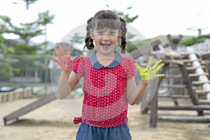 Asian girl show her hand after study art subject