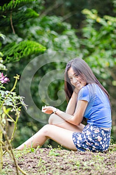 Asian girl sit down path in Bamboo forest