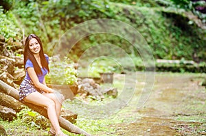 Asian girl sit down path in Bamboo forest