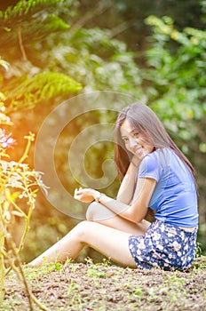 Asian girl sit down path in Bamboo forest