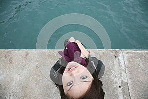 Asian girl sitting on edge