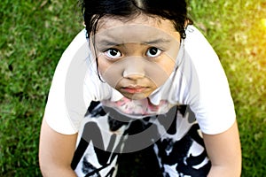 Asian girl sitting on floor at home. Bullying and isolation concept.