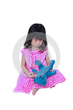 Asian girl sitting with toy bear, sadden and crying. Isolated on white