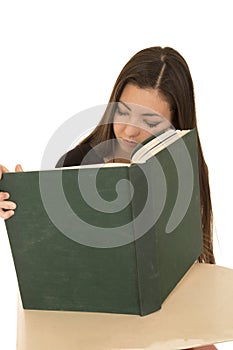Asian girl sleeping at school desk hold her book