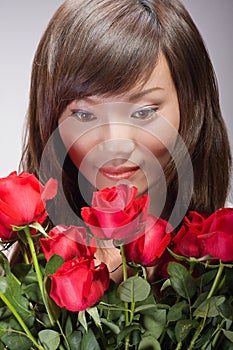 asian girl smelling roses