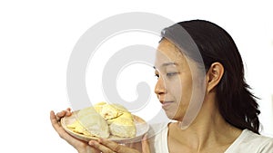 Asian girl smelling stinky durian. Smelly fruit of tropical area