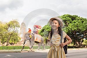 Asian girl smile happily,tourists on an ride elephant tour background,Ayutthaya,Thailand,summer vacation,travel concept.