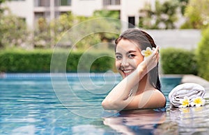 Asian girl smile Relaxing in the outdoor spa pool