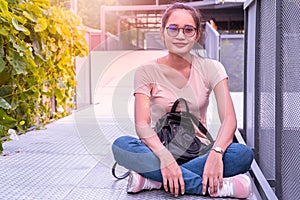 Asian girl smiling in garden.