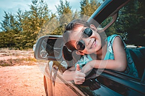 Asian girl smiling with perfect smile while sitting in the car.