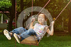 Asian girl smiling on a swing