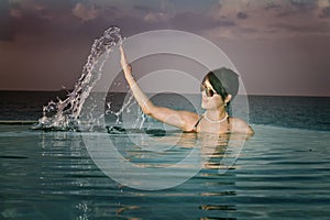 Asian girl snorkeling in crystal clear water