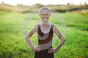 Asian girl in sportswear running across field, morning workout