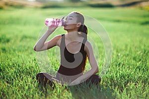 Asian girl in sportswear running across field, morning workout