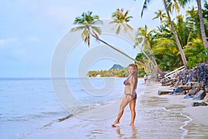 Asian girl stands on the beach - an afro pigtails near a tanned girl