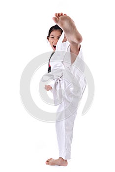 Asian girl stretching leg in martial arts practice training kick.