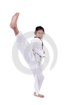 Asian girl stretching leg in martial arts practice training kick.