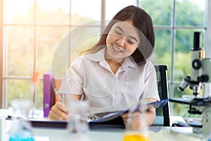 Asian girl students are doing science experiments in a science lab