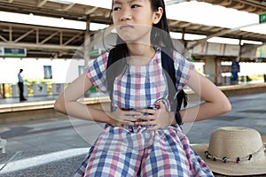 Asian girl suffering from stomachache photo