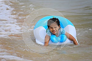 Asian girl in swimming at seaside with a smile on happy