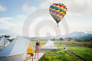 Asian girl take a hot air balloon photo by camera in Countryside homestay photo