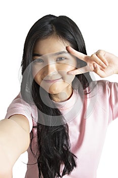 Asian girl taking selfie photo while doing v sign with smileing