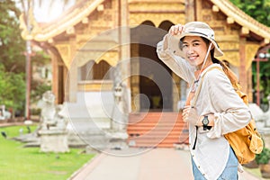 Asian girl teen enjoy smiling travel at Thai temple in Chiang Mai Northern province of Thailand