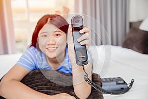 Asian girl teen with landline phone call happy smile impressive with customer care support concept