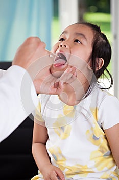 Asian girl during throat examination